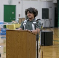 Photo of student Antonio Alcantara-Roldan speaking at a podium.